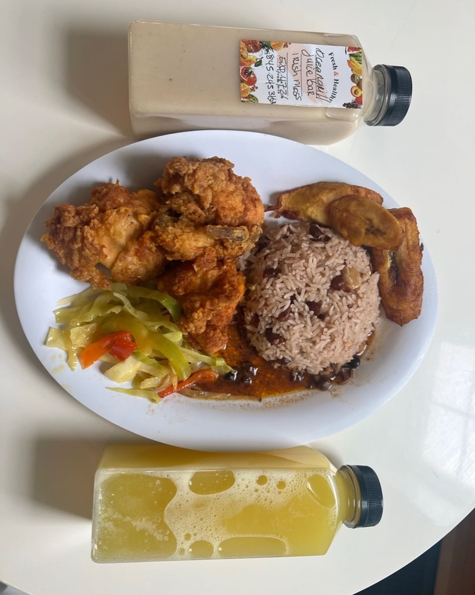 Fried chicken plate with rice and peas, plantains, and fresh juice
